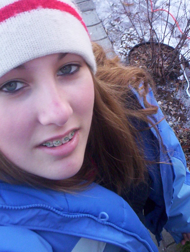 A selfie of a young Deanna Way in a blue jacket outside illustrating her long-standing love of photography